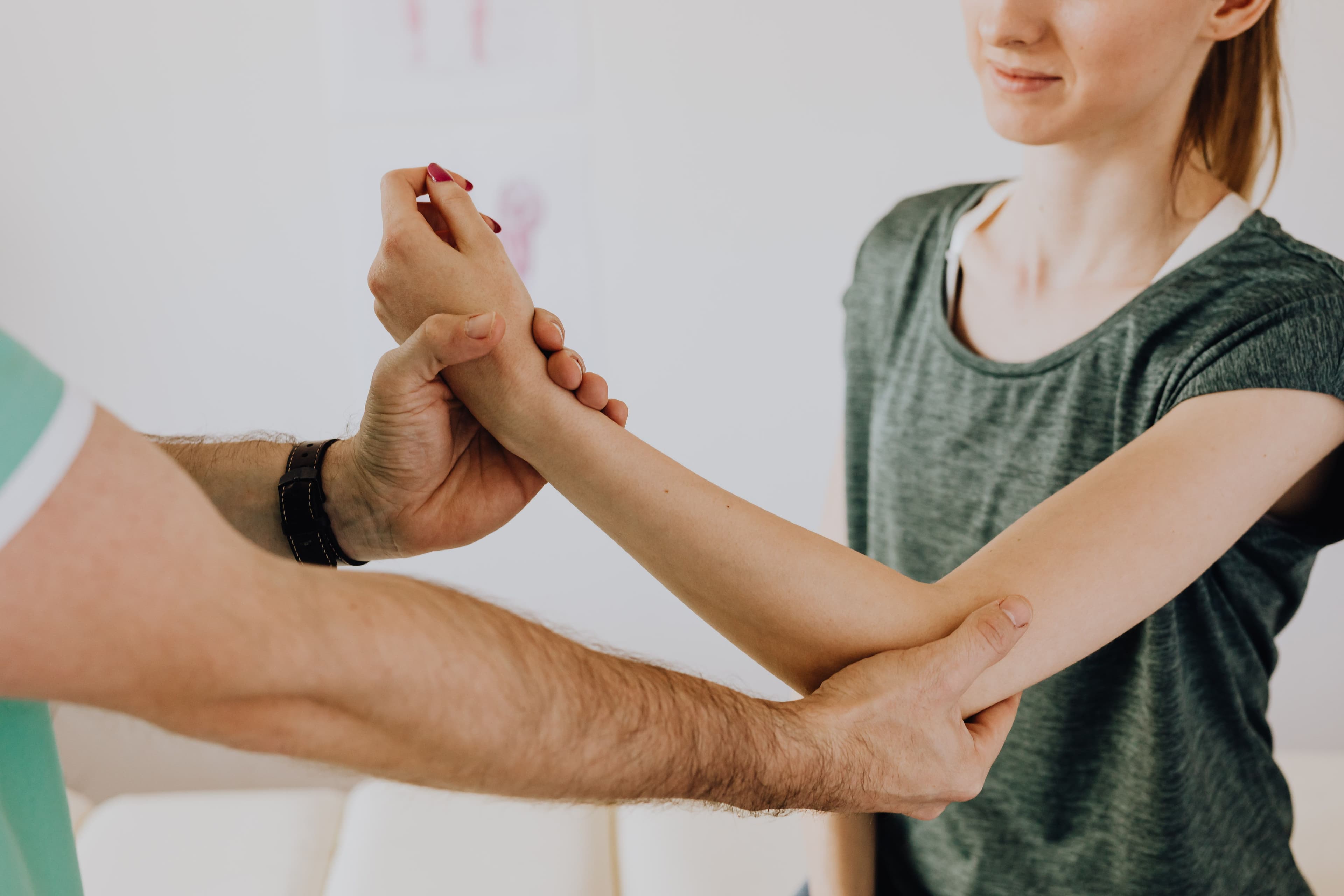 Therapist assessing a patient's arm mobility